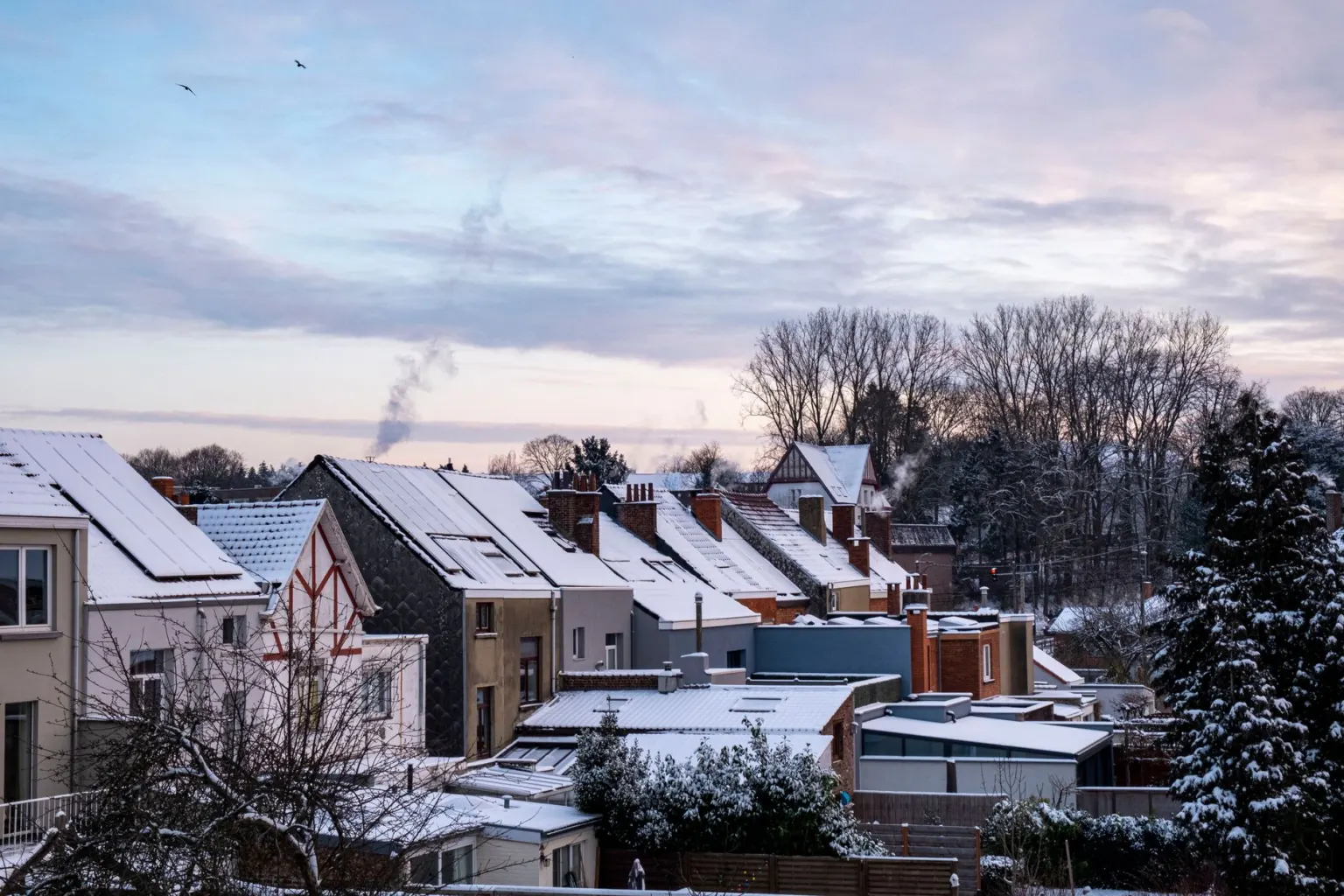 Property roof covered in winter snow