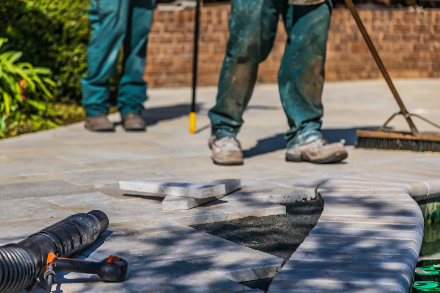 Groundworker laying paving during landscaping work