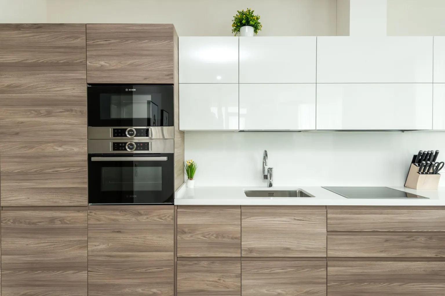 Modern fitted kitchen with wood cabinetry and integrated appliances